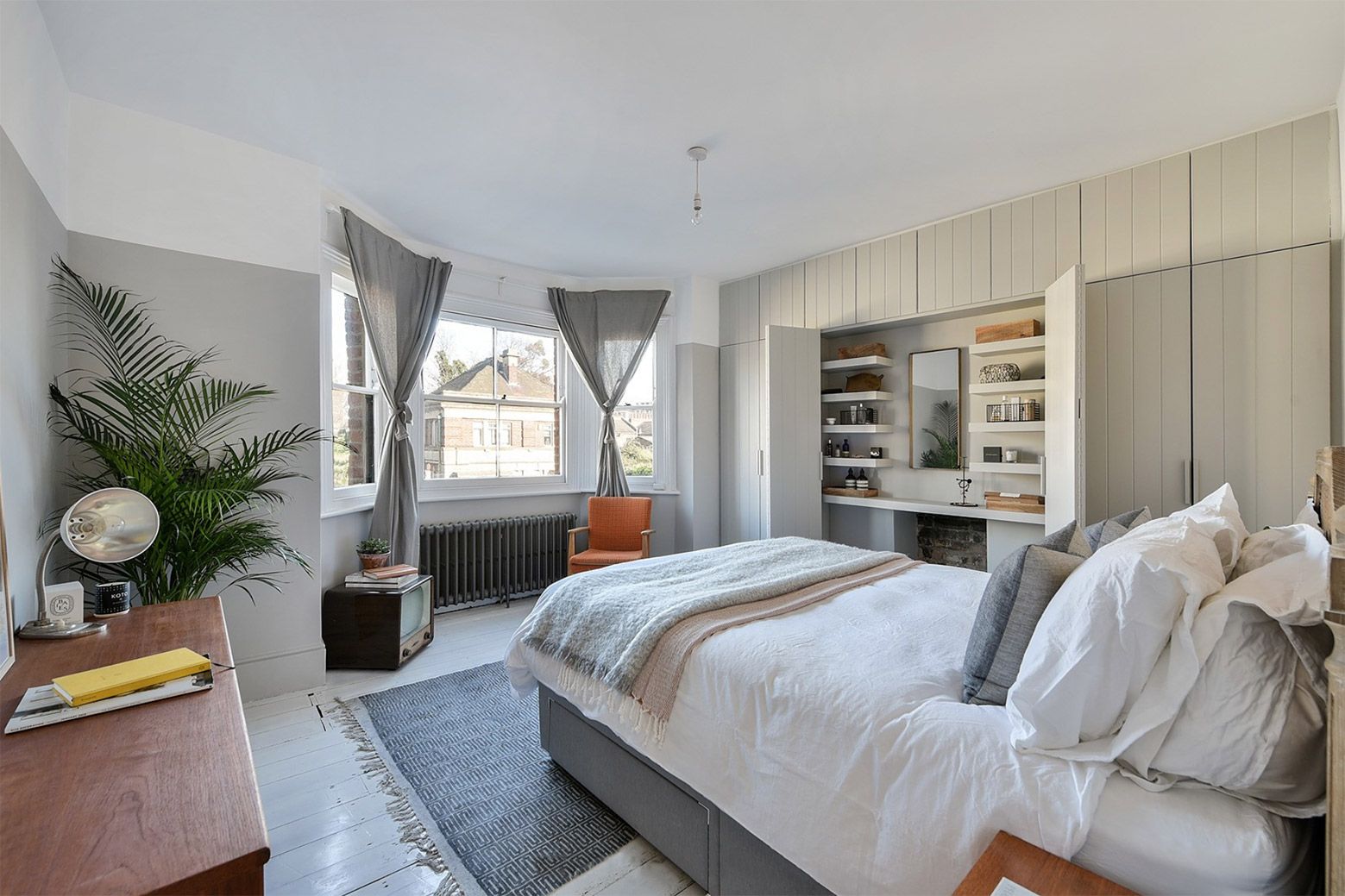 The calming bedroom at Nash, featuring neutral wood paneling